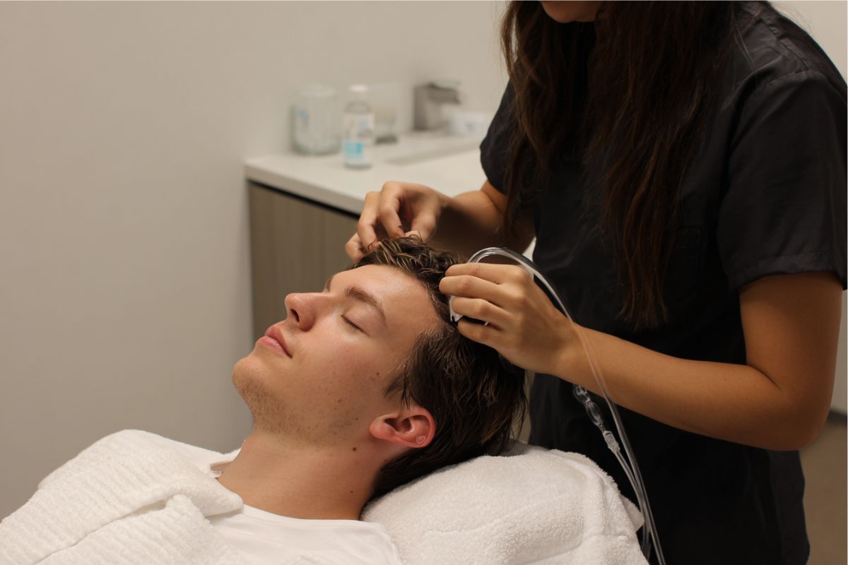 The man is undergoing scalp treatment.
