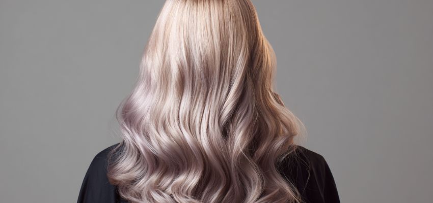 Woman with trendy ash color hair highlighting cool-toned style