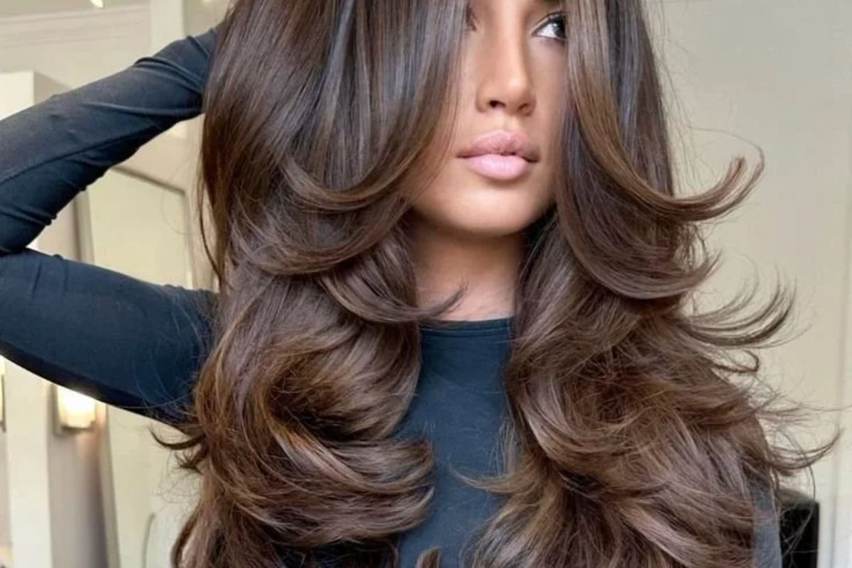 The woman has a butterfly cut hairstyle.