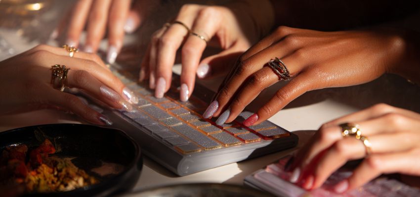 Women choose a stunning set of fake nails.