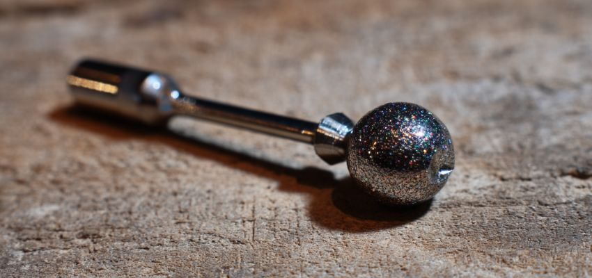 Sparkly round ball-shaped nail drill bit displayed as part of different nail drill bits explained