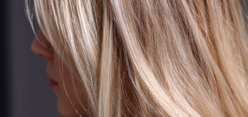 Close-up of healthy blonde hair strands after toning, illustrating the results when considering does toner damage hair questions